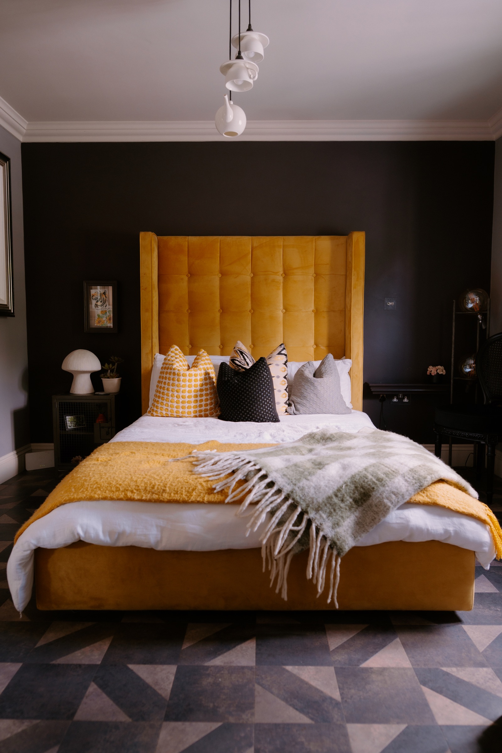 Dark bedroom with ochre bed