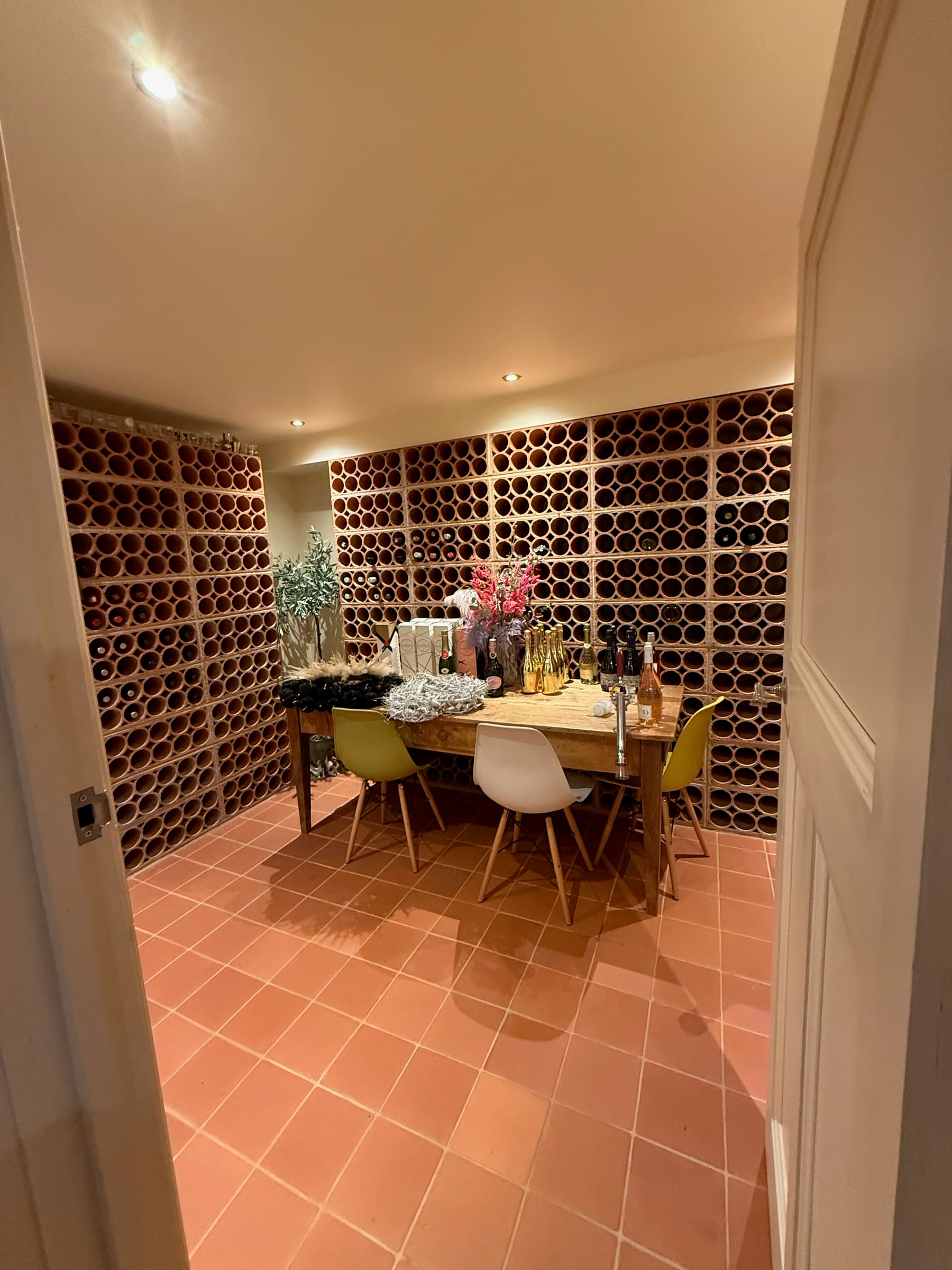 Cellar wine room with terracotta floor and bottle wall