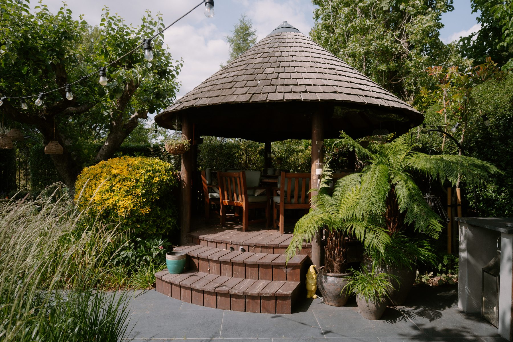 The timber Breeze House surrounded by mature planting